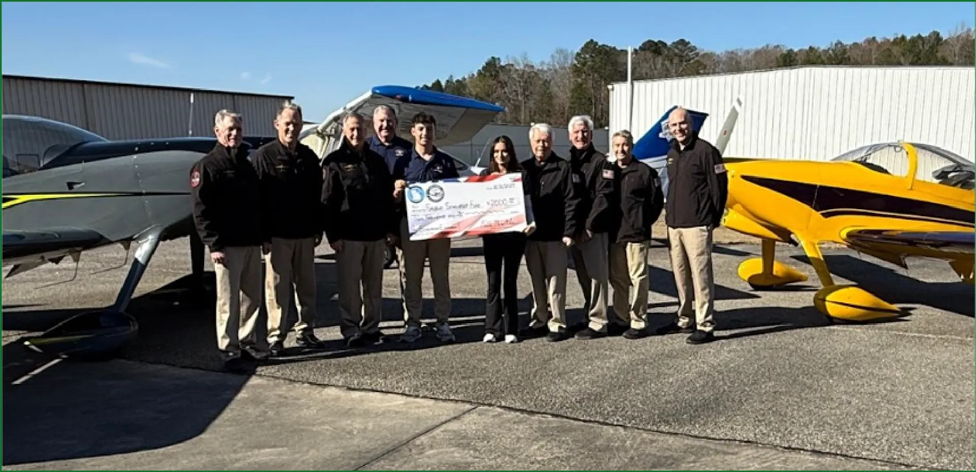Speedway Aviation Scholarship - Full Throttle Formation Team donation check presentation with all team members